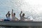 Waving young men silhouette driving powerboat