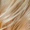 Wavy blonde woman hair background and texture