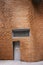 Wavy brick wall of Dr Chau Chak Wing Building with offset bricks, louver and door at University Technology Sydney UTS, Australia