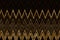 Wavy golden zigzag stripes on black backgrond. Horizontal chevron pattern. Digital illustration
