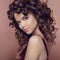 Wavy hair. Attractive smiling girl with makeup. Curly hairstyle.