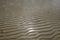 The wavy horizontal striped pattern formed by the sand of an Irish beach