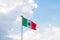 Wavy Mexican flag with a cloudy sky as background