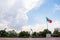 Wavy Mexican flag in public square with a cloudy sky as background