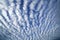 Wavy and rippled white clouds in blue sky, abstract nature patterns
