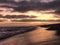 Wavy sea under thunderhead sky at sunset