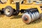 Wavy shaped disc harrow for field work on an agricultural tractor on a sunny day