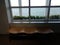 Wavy wood bench with window and sea water