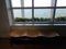 Wavy wood bench with window and sea water