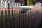 The wavy wood fence near the road in the colours of car traffic lights