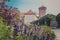 Wawel Senator Tower with castle, lawns, ivy, umbrellas, flowers and bushes