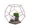 Wax candle in glass and metal geometric terrarium holder. Scented aromatic decoration. Modern cosy decorative glowing