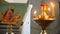 Wax candles burn with flames near the icon in the Orthodox Church
