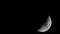 Waxing crescent moon moving in the night sky