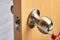 Way of attaching the doorknob using exposed set-screws to secure the handle to a threaded spindle