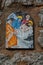 Way of the cross. 14th Station. The body of Jesus is placed in the tomb. Hand painted ceramic tile, Ingurtosu, Arbus, Sardinia