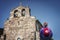 On the Way of St. James a pilgrim contemplates the beauty of the church of Santiago in Baamonde, Spain. Built in the 9th century