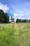 Way to abandoned brick temple in summer meadow, Russia