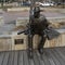 `Wayne Ferguson` by artist David Iles of Bolivar Bronze along the boardwalk of Wayne Ferguson Plaza in Lewisville, Texas.