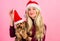 Ways to have merry christmas with pets. Woman and yorkshire terrier wear santa hat. Girl attractive blonde hold dog pet