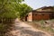 Wayside abandoned 1970s` red brick workshops in sunny spring