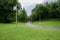 Wayside cctv camera in lawn on cloudy summer day after rain