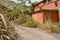 Wayside deserted 1970s` red brick workshop in weeds of sunny spring