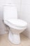 WC pan in white tiled bathroom