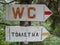 WC tourist signs neare near Devil\'s Throat cave near the village of Trigrad Bulgaria