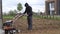 Weak man start engine of cultivator and work hardly in townhouse yard