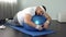 Weak-willed fat man relaxing on fitness ball, home workout break, laziness