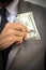 Wealthy handsome. Close-up of young man in formalwear putting money