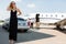 Wealthy Woman In Elegant Dress At Airport Terminal