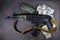 Weapon and money. A new assault Kalashnikov AK 74  M machine gun and dollar cash. Criminal news story background