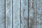 Wearhered wood boards background of brown planks with partially erased light blue paint