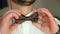 Wearing bow tie close up. Check correct and adjust casual brown bow tie