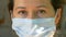 Wearing a medical mask during the Covid epidemic. Close-up of a young woman's face