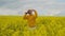 Wearing sunglasses and a field of yellow flowers, the Male soloist in yellow clothes dances and sings an energetic song