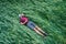 Weary farmer lying with tablet in hands and sleeping on wheat field