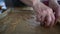 The weary hands of a female baker lay out the cookies on greaseproof paper for baking. Baking tray with gingerbread