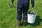 Weary man hold bucket full of fishes and rod