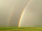 Weather Double Rainbow rain over green field rural farm landscape