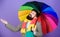 Weather forecast concept. Man bearded hipster hold colorful umbrella. It seems to be raining. Rainy days can be tough to
