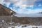 Weather station in mountains. Rocks, snow and stones in mountain valley view. Mountain panorama.