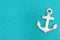 Weathered anchor on a turquoise glitter background