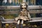weathered antique doll sitting alone on a park bench