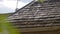 The weathered asphalt shingles of a gabled roof