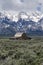 A weathered barn sits against the backdrop of the Grand Tetons in Wyoming,