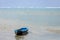 Weathered blue canoe floating in the Sea off the coast of Roatan