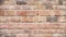 Weathered brick wall, solid construction material, old fashioned building design generated by AI